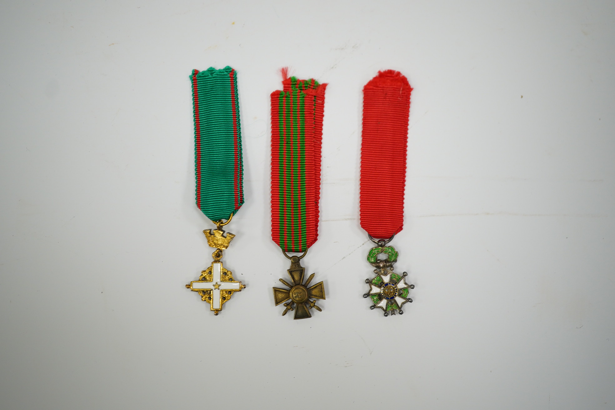 A framed medal group; Legion D'Honneur France, a British Cross, Italian order of Merit and Croix De Guerre with related book; La Legion d’Honneur by Jean Daniel, plus some related paperwork, three related medal miniature